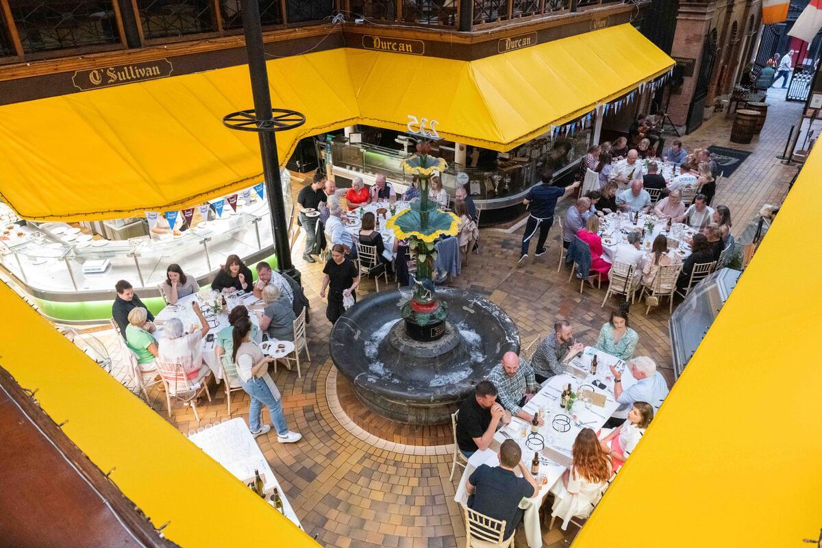 Diners seated around the fountain inside Cork's English Market during Cork on a Fork Food Festival